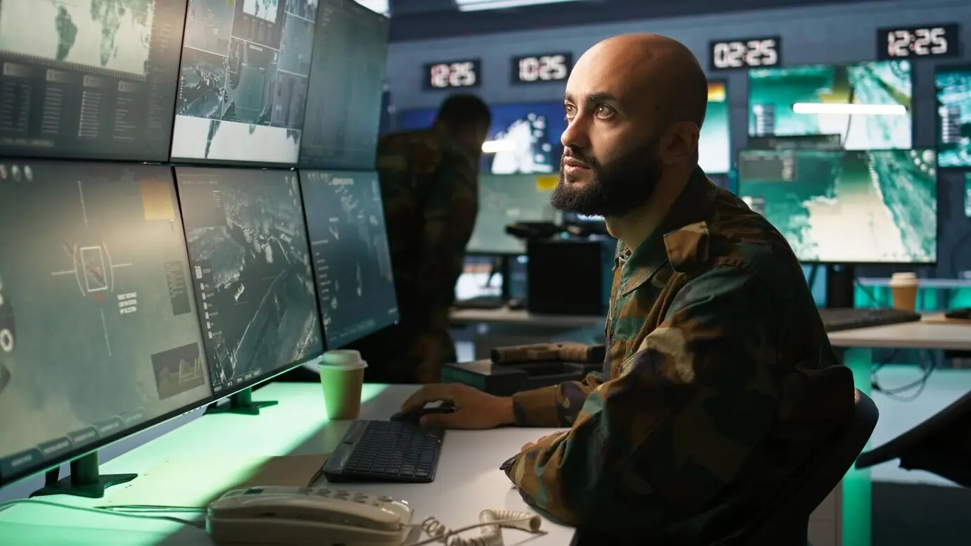 Close-up of devices as an Army specialist oversees national safety operations.